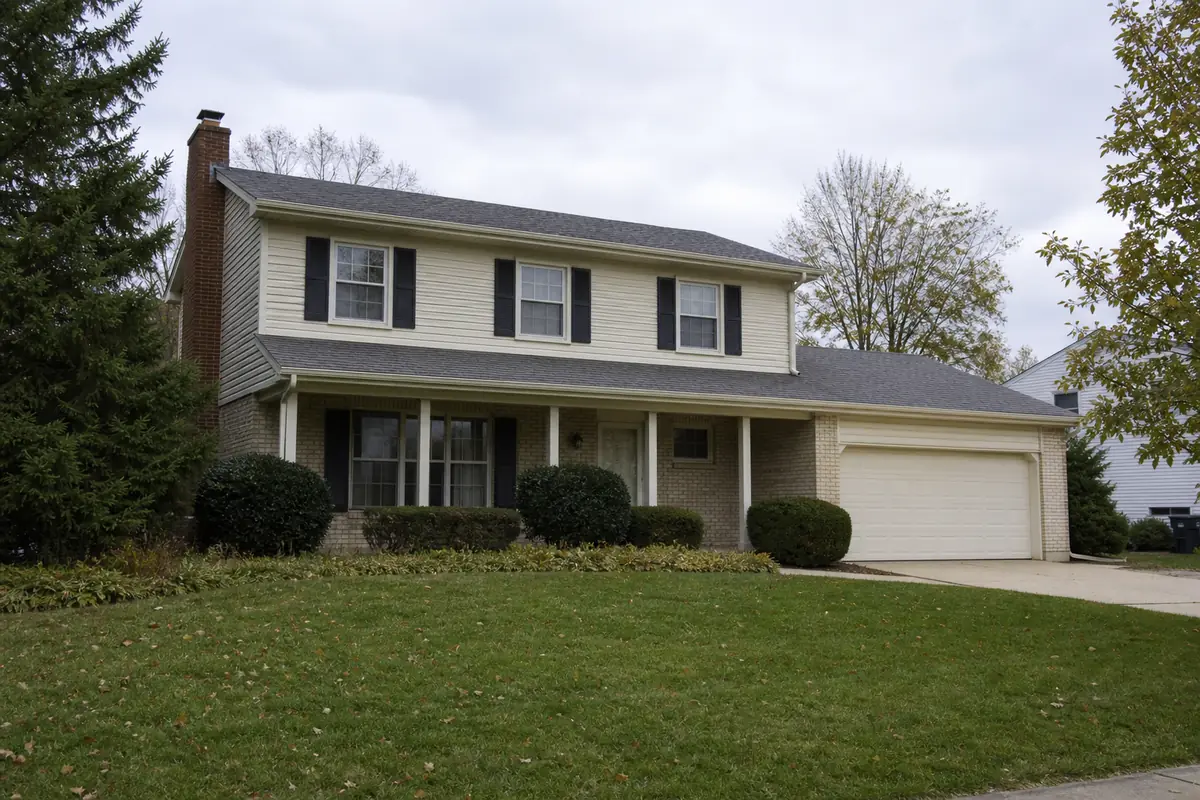A 1970s two-story colonial with shutters and an attached two-car garage — sell my house fast brookfield — Cudahy, WI