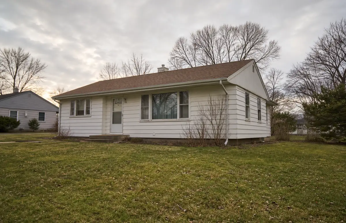 A 1960s side-gabled ranch with a picture window and a wide lawn — sell my house fast greendale — Cudahy, WI