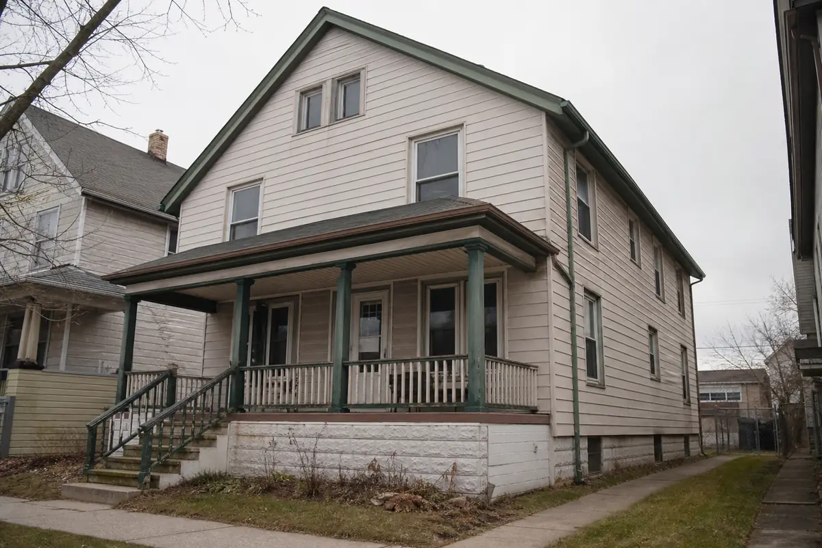 A Milwaukee-style duplex two-flat with a full-width front porch, clapboard siding and — we buy houses milwaukee — Cudahy, WI