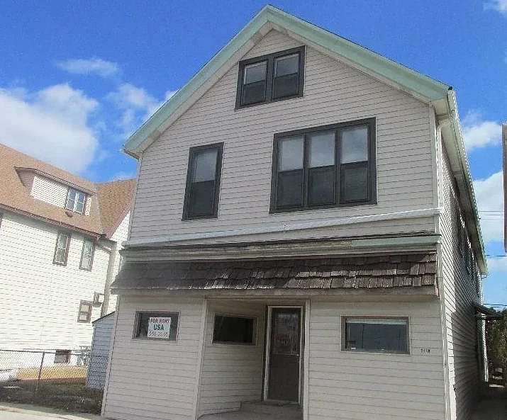 The four-unit building at 5118 S Packard Ave in Cudahy that houses the company office — we buy houses cudahy