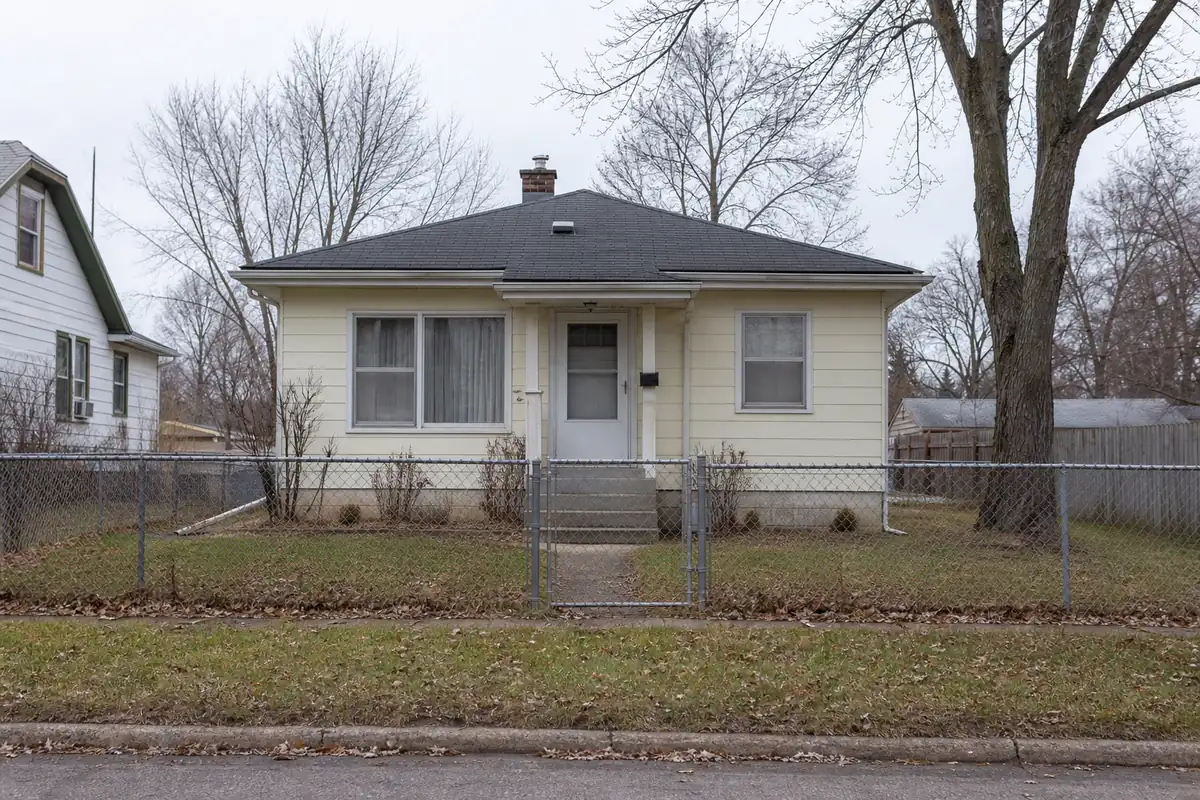 A modest 1950s bungalow with a low front stoop and a chain-link fenced yard — sell my house fast south milwaukee — Cudahy, WI